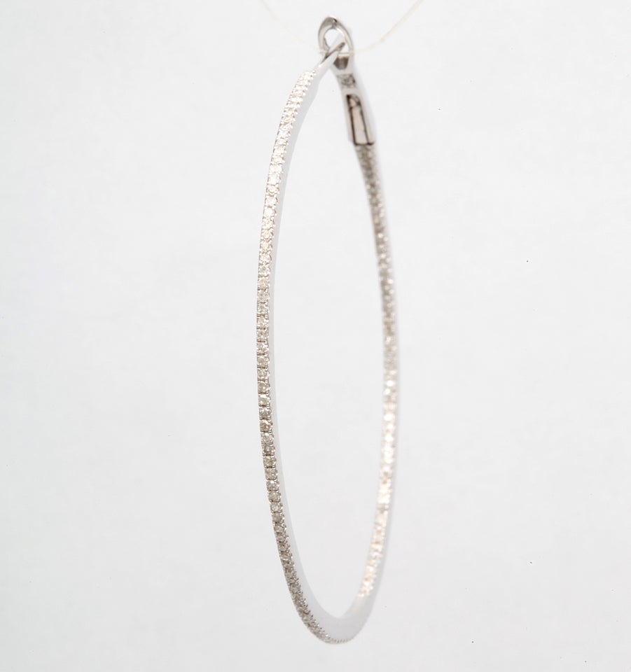 Diamond hoop earrings weighing 0.65 cts, in 14k white gold.