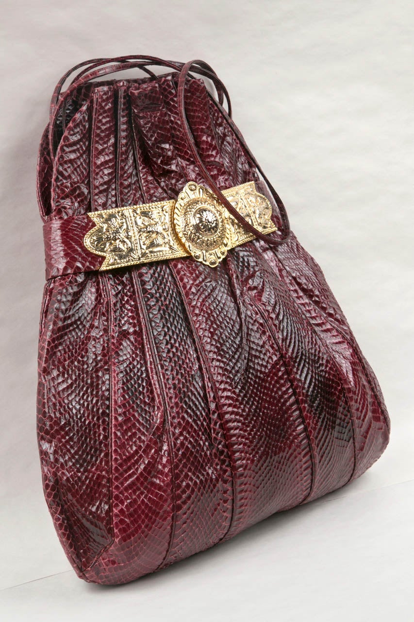 large judith leiber burgundy python shoulder bag featuring a statement egyptian revival style fitting. 
  

condition
very good vintage condition