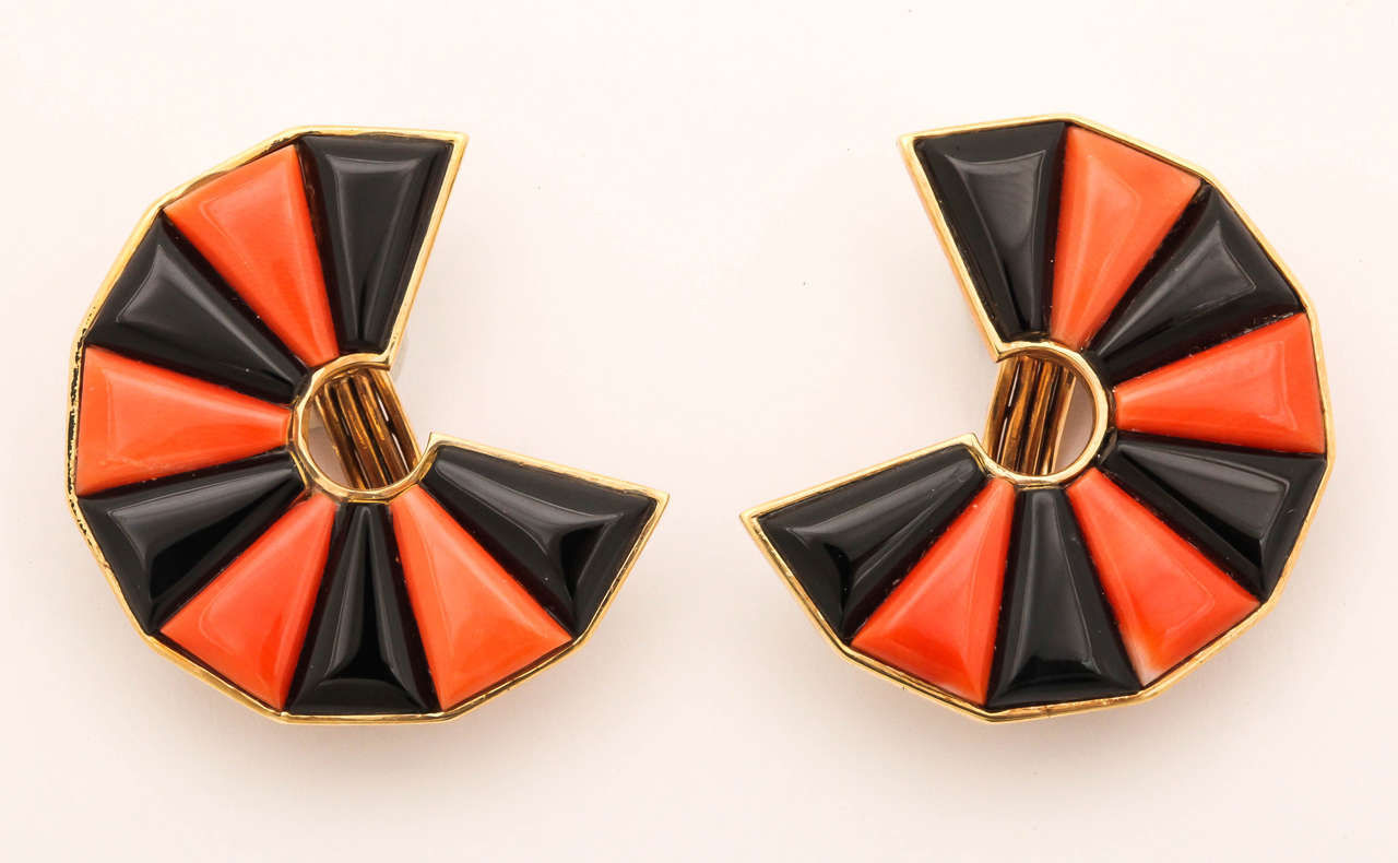 These uniquely cut stones are from the 40s, found in a retired jeweler's inventory. The shape of the earrings are also reminiscent of that period when fan shaped earrings were the rage. The fan is an elegant shape that  brackets  and features the