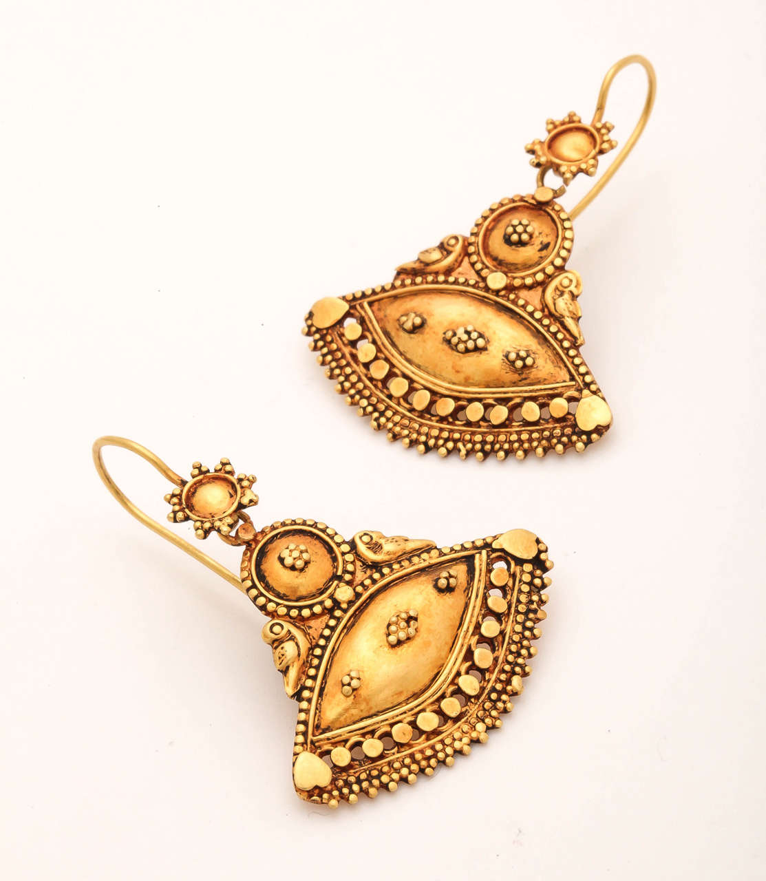 Feel like an exotic princess from the tropical climes. These 18 kt earrings are beautifully handmade with gold granules and disk fused onto the body of the earring. They are plated with 24 ct gold and oxidized to give them an antique feeling. The
