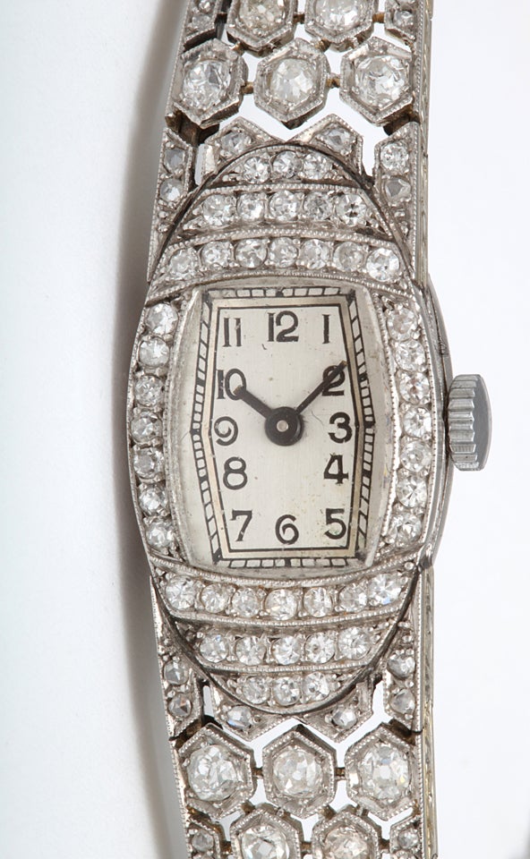 A dazzling period Art Deco diamond watch with adjustable platinum band mesh that finishes in a honeycomb of set mine diamonds holding a Swiss made diamond-faced watch