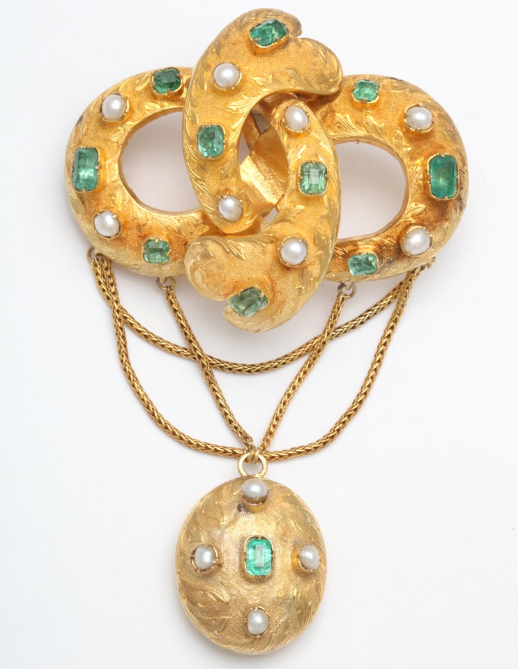 Sumptuous Faceted Emerald & Natural Pearl Victorian Brooch, prong set, with an oval Hair Locket suspended from criss cross woven Gold Chains