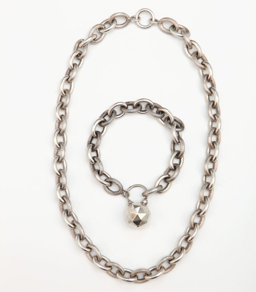 A lovely antique chain link necklace and matching bracelet in sterling silver. The bracelet has a hollow construction 