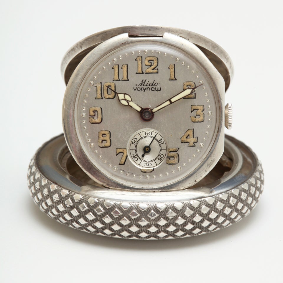 A rare Mido travel watch in the form of a Bugatti wheel, circa 1930s, the case designed by Jules Huegenin, in silver (.935), to represent a spoked wheel with tire from a Bugatti car from the 1930s. The silvered dial is signed 