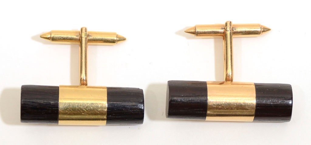 A rare pair of barrel shaped cufflinks by William Spratling (1900-1967) in 18 karat gold and wood.  The cuffs are marked with an impressed WS mark and an 18K mark from the 1956-67 period.