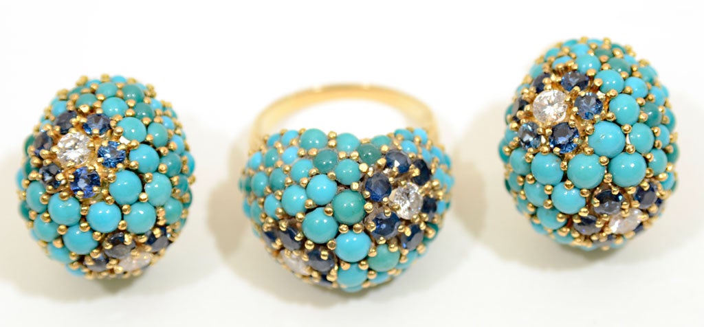 A 14 karat gold earring and ring set highlighted with turquoise, diamonds and sapphires in a raised button design.  Available individually.  Ring fits an 8 1/2 to 9 size finger.  Earrings are fitted with posts for pierced ears.  The ring is priced