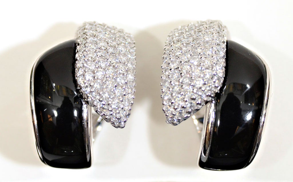 Platinum earrings by Robert Wander with diamonds and black onyx.  They are signed with Wander's hallmark, WINC, and a  platinum mark. The earrings contain approximately 2.25 carats of diamonds.  The earrings are also convertible, that is, they have