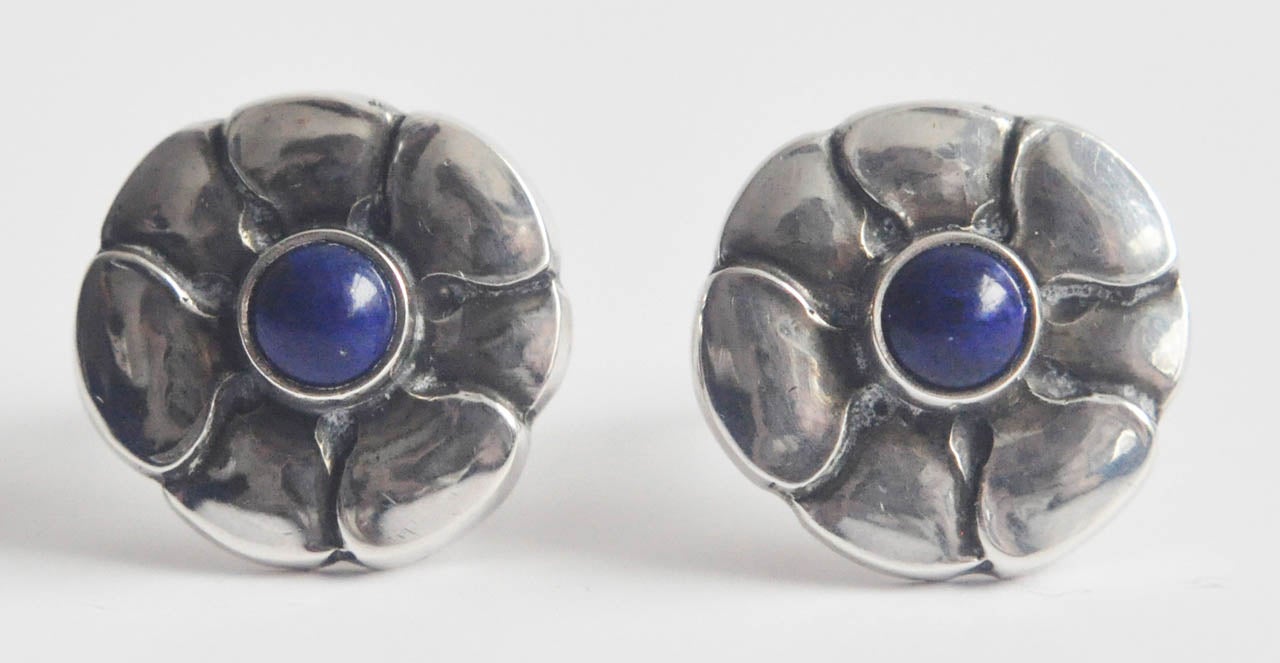 Hand-wrought sterling silver clip earrings with lapis lazuli set in an original Jensen setting of stylized flowers.  A very comfortable fit.