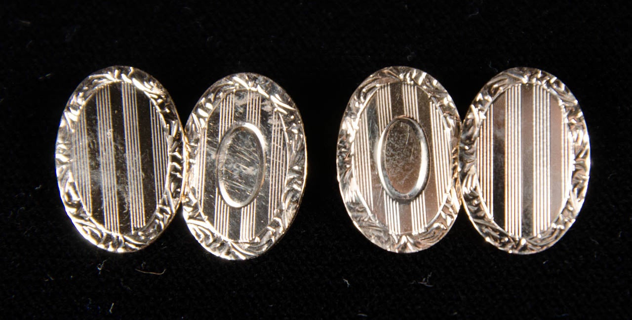 These oval form cufflinks feature an engine turned Art Deco geometric engraving.They are marked 14k as well.