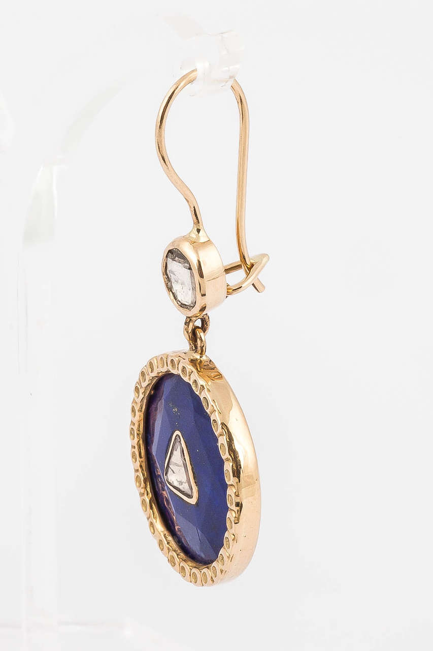 These stunning earrings are made from 22carat lapis stones with 1.2carat diamond nestled in the centre. Set in 18k gold these earrings are timeless.