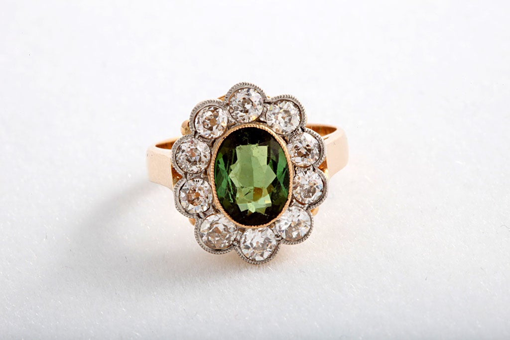 This beautiful ring contains a 2.15c chrysoberyl surrounded by 10 Old European cut diamonds (approximately 1.20 carats).  The mounting is platinum topped on 18k gold.<br />
<br />
Size 5.5 US - it can be sized