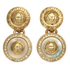 Gianni Versace white and gold dangling earrings with Medusa motifs