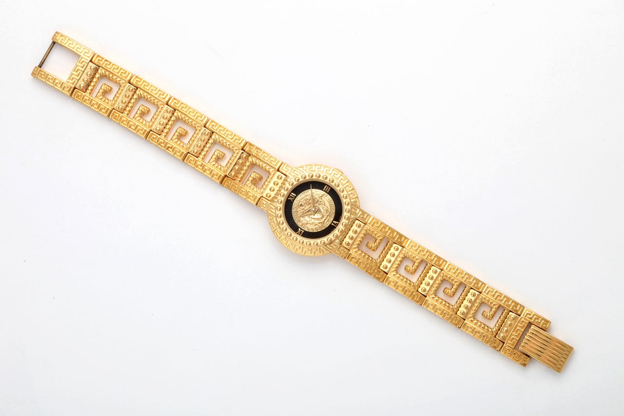 Very rare Gianni Versace women's gold watch with Medusa and Greca motif belt.

Watch face width 1 inch, height 0.8 inch