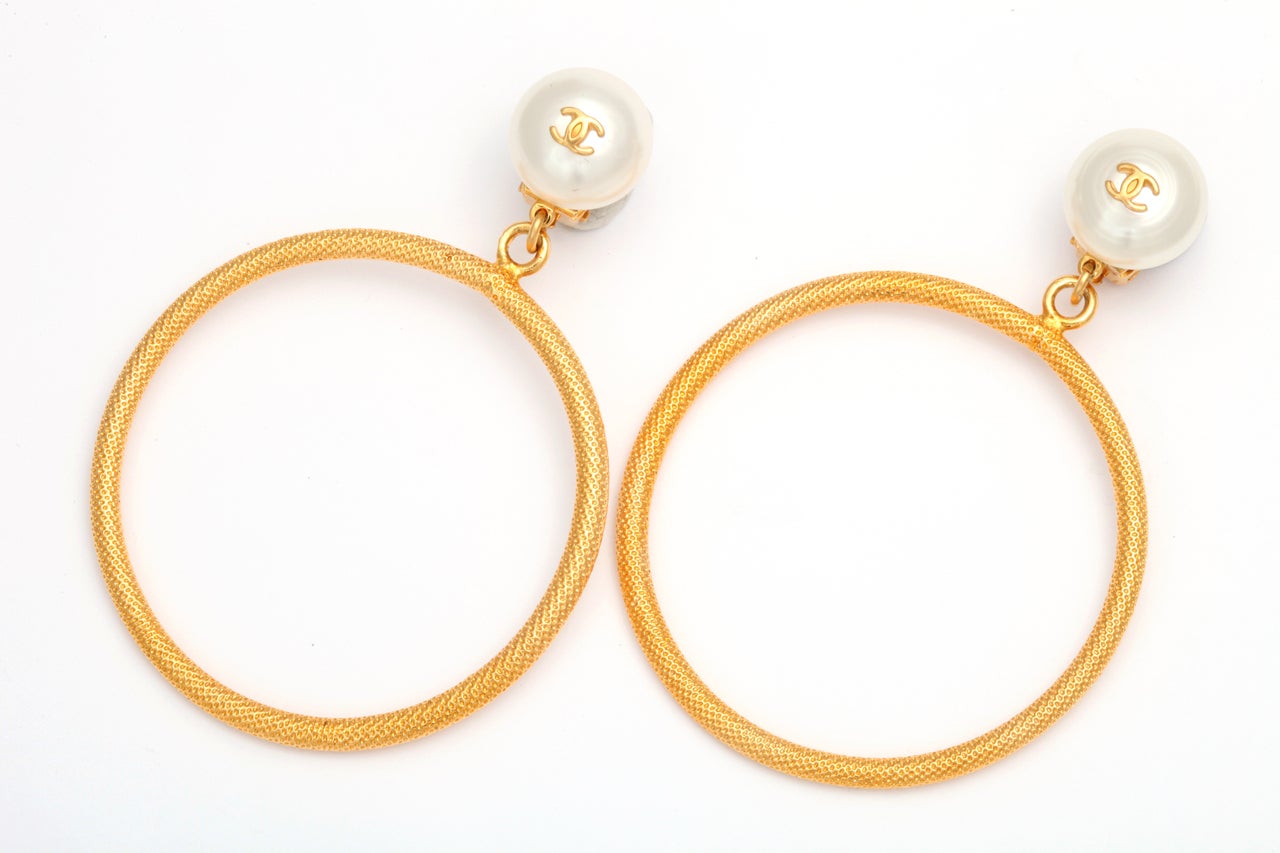 Beautiful Chanel large circle dangling earrings with pearls and CC logos.