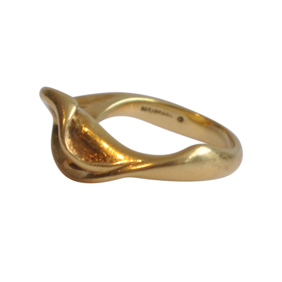 18K gold ring by Italian designer Elsa Peretti with a simple and elegant organic design.  Her highly regarded collaboration with Tiffany & Co began in 1974 and continues today. Signed PERETTI 18K and Tiffany & Co.
Approximate size: 7 3/4
