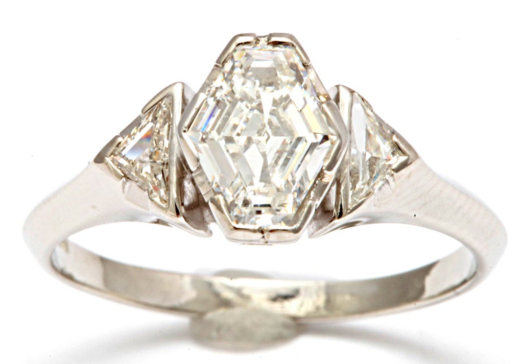 Rarely do you see a hexagonal cut diamond.  A platinum band holds the finger of your love and keeps the 1ct. faceted hexagonal gem on her for life.  The geometry is fascinating for as you look into the gem, the hexagons get gradually smaller as they