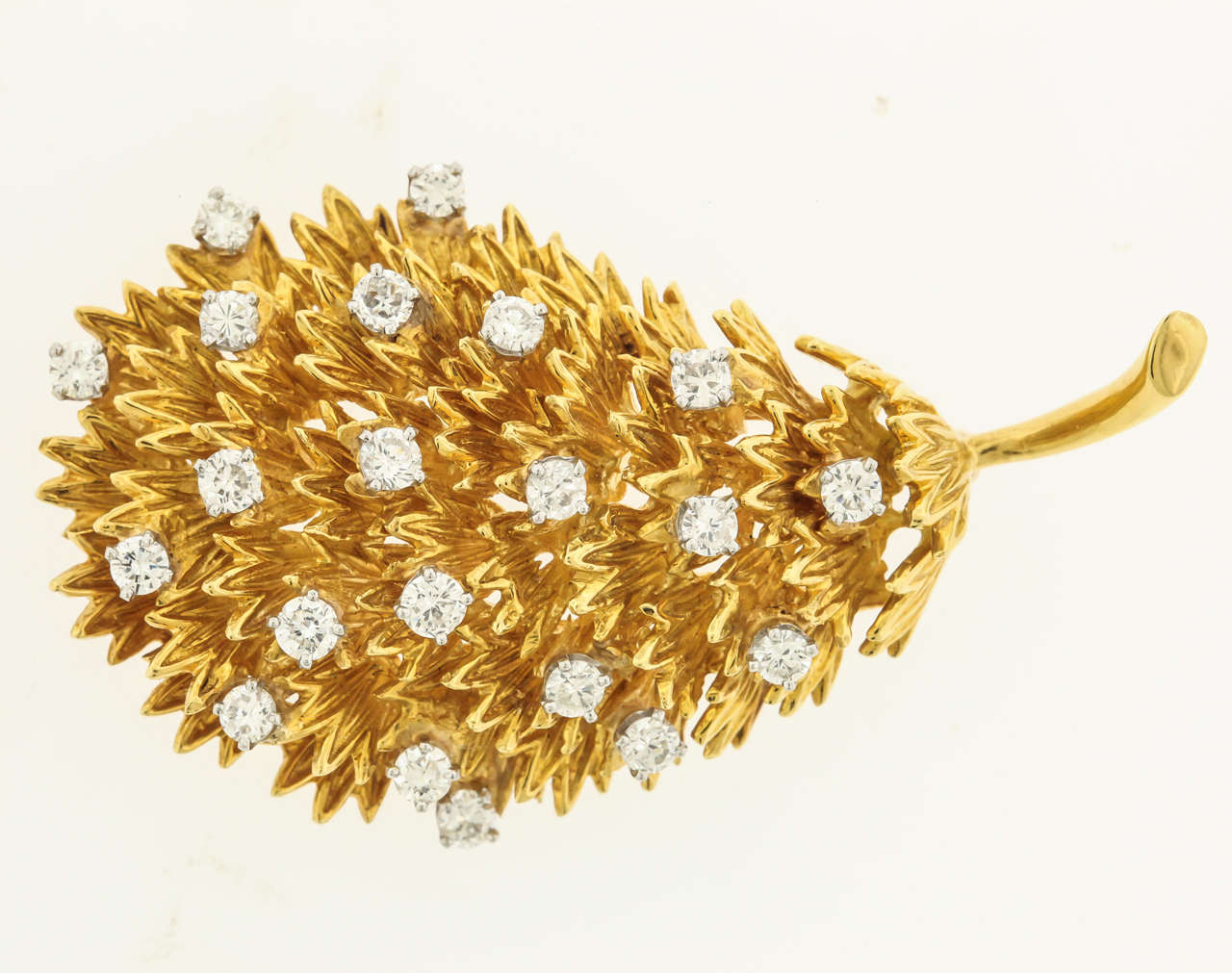 18K yellow gold and diamond brooch is composed of 18K leaves in a three-dimensional pin studded with 21 full-cut diamonds, approx. 2.10 carats. The brooch measures 1-1/4