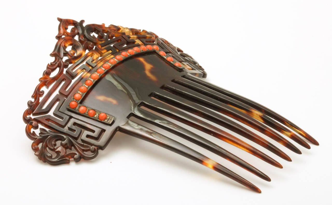 A work of art for the hair is our sense of this beautiful comb of tortoise vines and geometric forms. Natural coral graces the front to highlight your hair. There are seven tongs offering a secure hold. It is a comfortable wearable size of 4 1/2