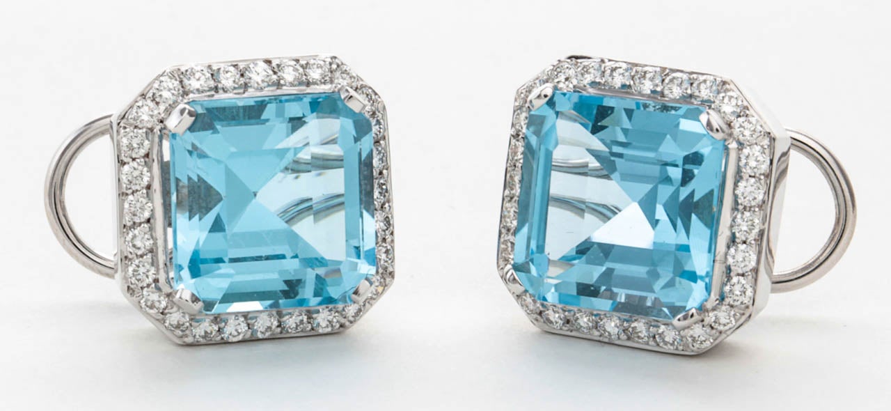 Gorgeous large emerald/asscher cut blue topaz surrounded by approximately 1.85 carats of diamonds. 

Set in 18k white gold.