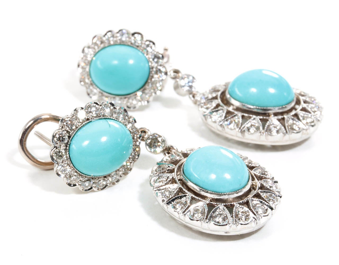 10 carats of beautiful blue turquoise, 2.05 carats of F color VS clarity diamonds. 

This earring is entirely handmade and engraved with fine detail.

Set in 18k white gold.

A beautiful earring to add to any collection.