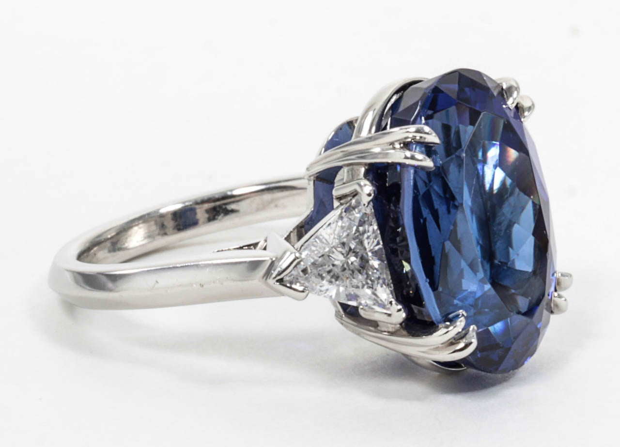 13.15 carat royal blue Tanzanite set in a custom platinum mounting with just under a carat of trillion cut diamonds.

This color Tanzanite is very fine and rare -- it has the color of a fine sapphire.