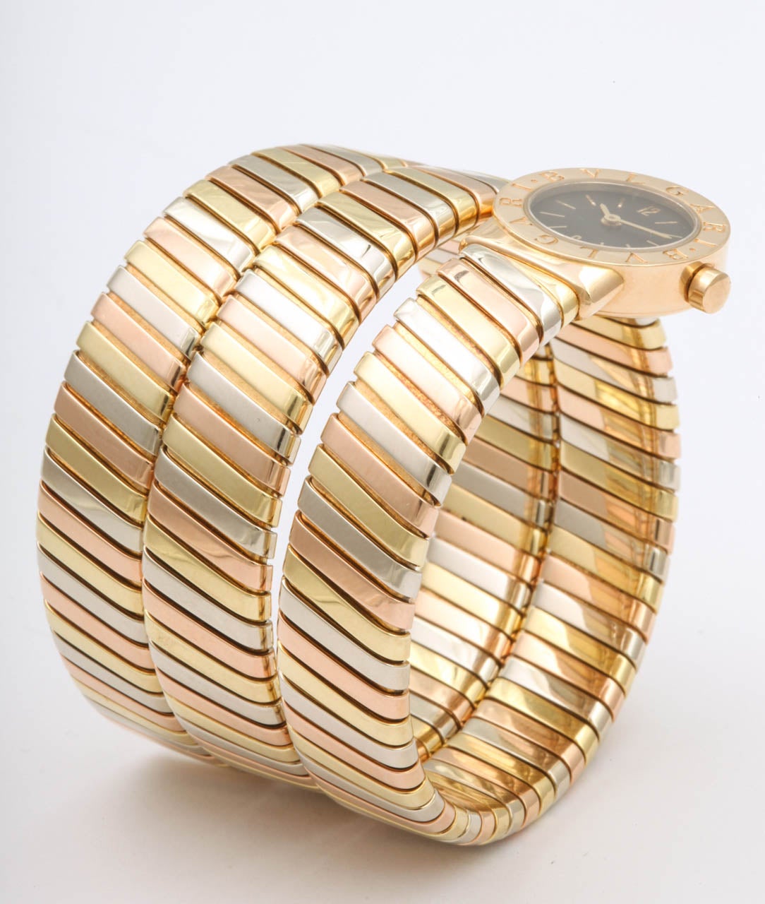 Bulgari lady's Tubogas Serpenti bracelet watch crafted in 18k yellow, rose and white gold.