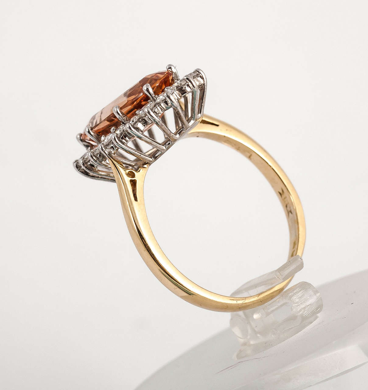 Fine colour Imperial topaz ring surrounded by diamonds set in 18ct Gold
Finger size N 1/4