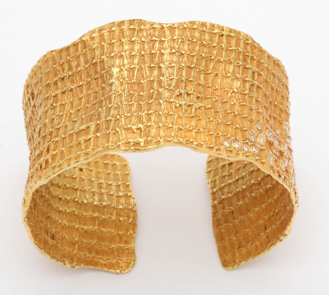 An 18kt yellow gold and diamond cuff. The cuff is fashioned after a piece of honeycomb and is set with approximately 1.45cts of diamonds.