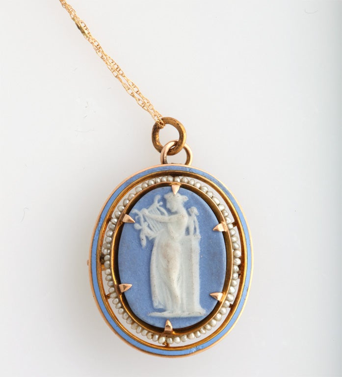 Lovely 14K gold, enamel and seed pearl Wedgwood Pendant, England, year marked for 1885. White mythological figure sits on blue Wedgwood plaque; bezel is matching light blue enamel; plaque is surrounded by seed pearls; @1