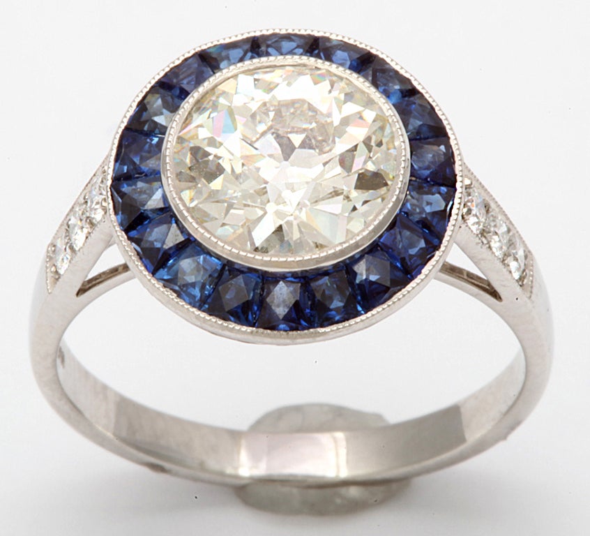 Art Deco style ring featuring a center round diamond weighing 1.89 cts, flanked with sapphires, 2.05 cts with a platinum diamond shank, .15 cts.