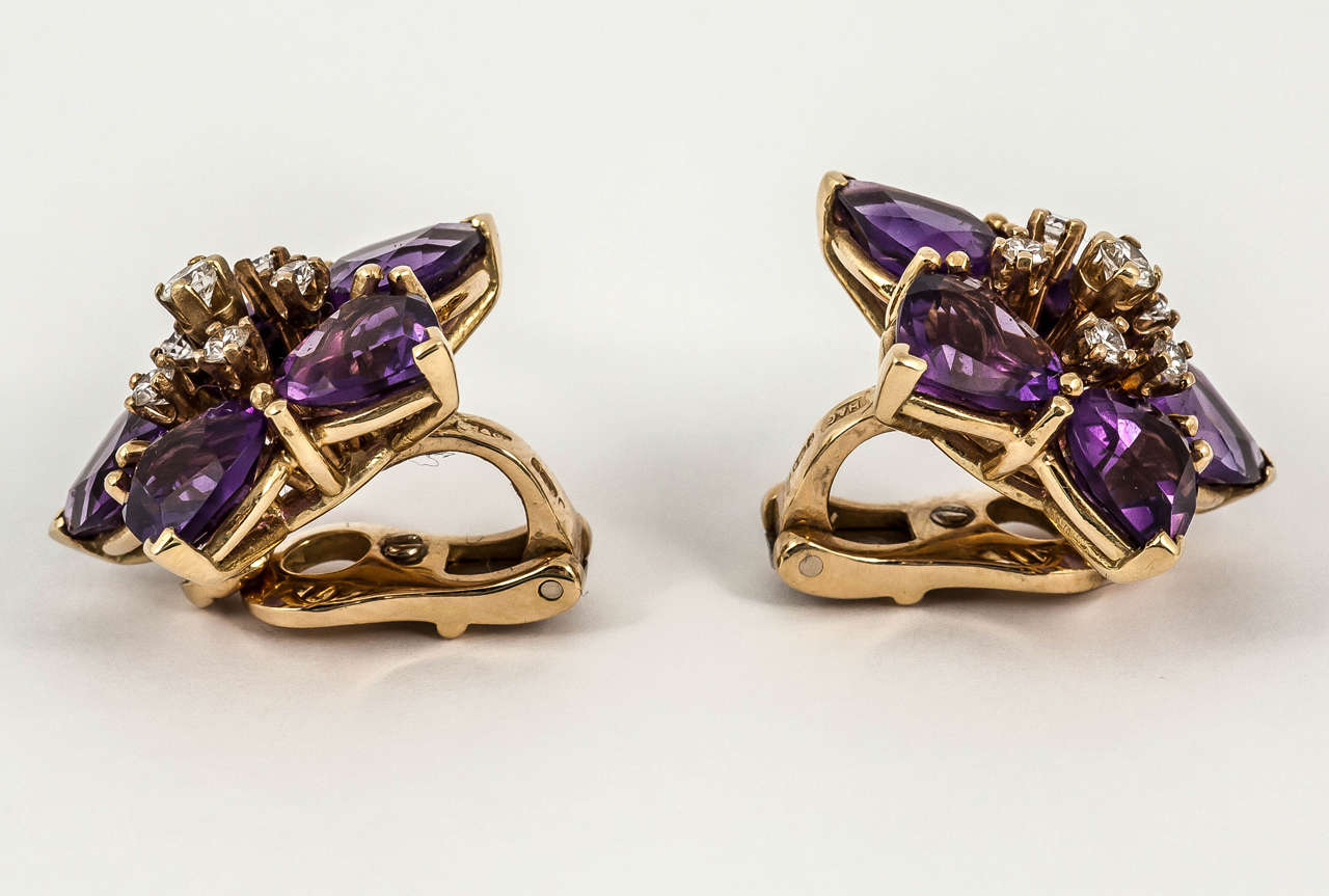 Pair of gold mounted clip earrings set with heart shaped amethysts and diamonds. Circa 1970.