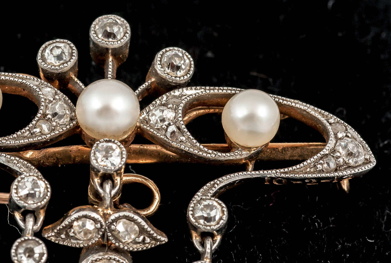 Late 19th Century natural pearl and diamond floral brooch/pendant mounted in gold and faced in silver.