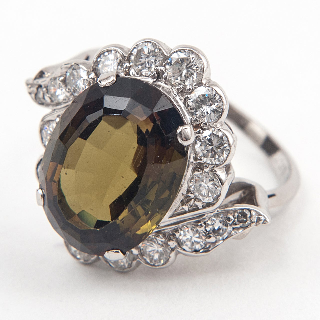 It is unusual to find Andalusite of gem quality in this size - and yet we have in this charming ring. Mounted in 18ct White Gold and Platinum, the diamonds are set in counterpoint to the central stone that changes colours in an exceptional manner