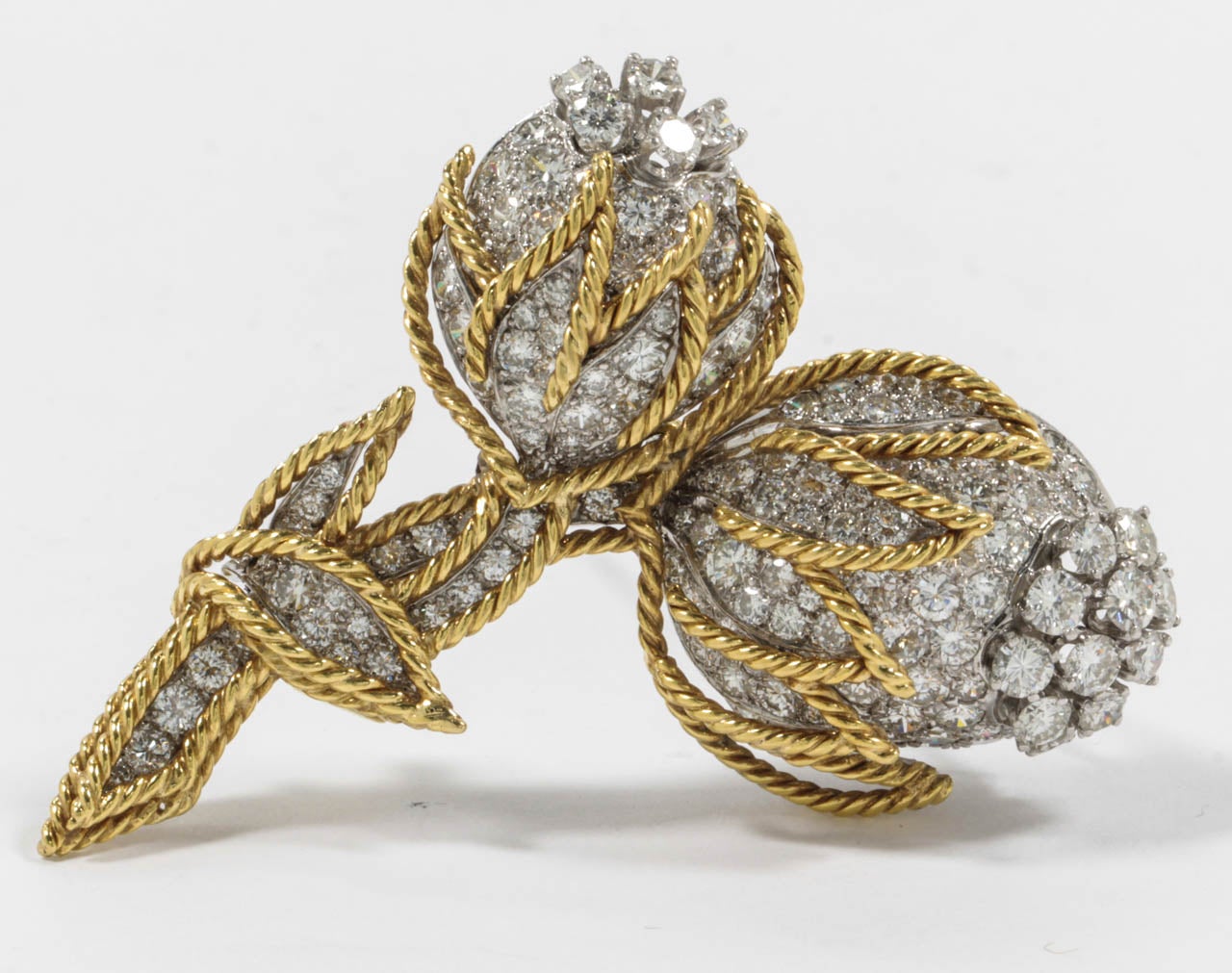 The diamond Flower set with brilliant-cut diamonds, in a Yellow Gold cage.