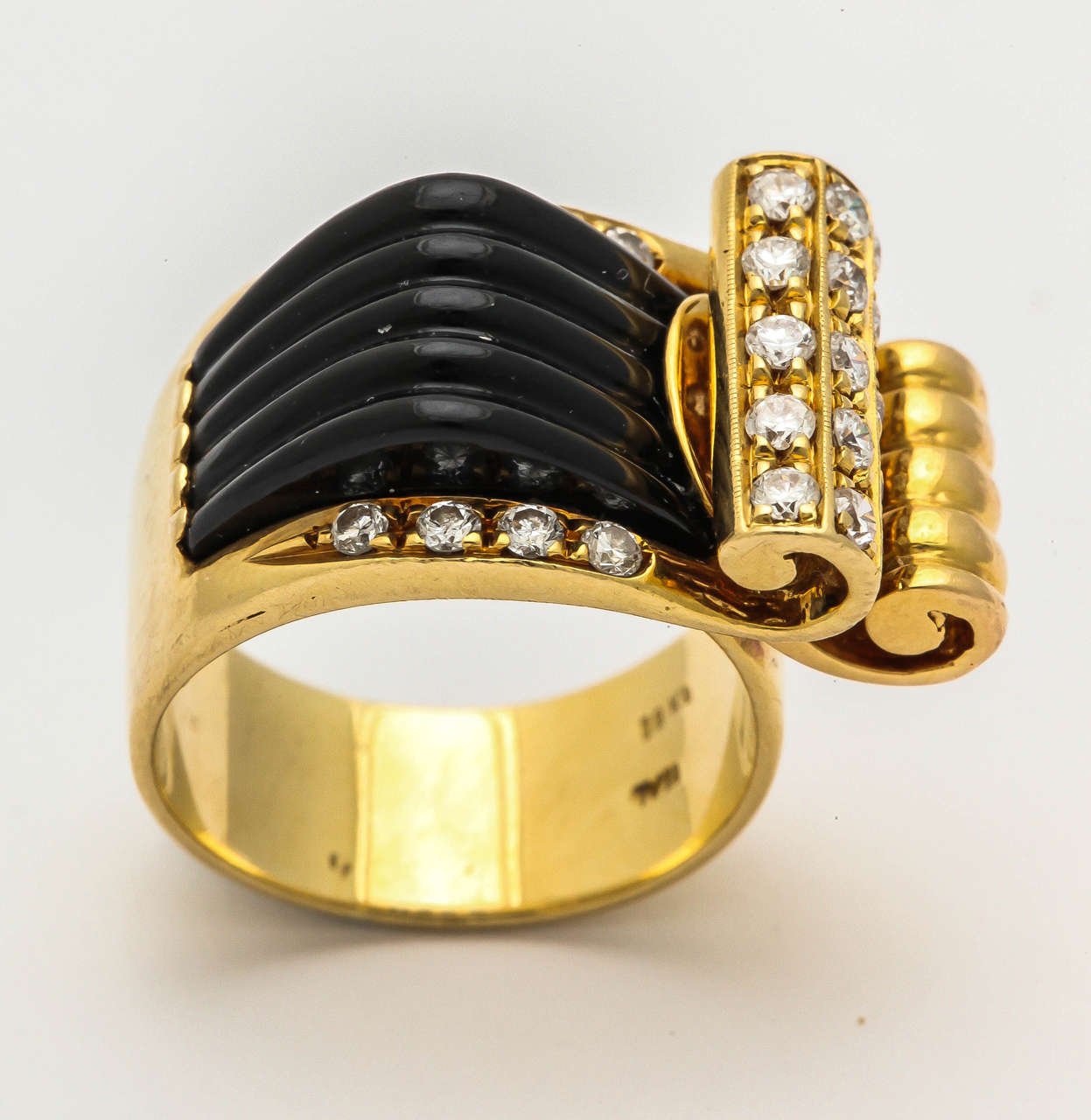 18kt yellow gold high style and architectural carved fluted onyx ridges cocktail ring consisting of an unusual curly cue gold design embellished with numerous full cut diamonds thruout the design of the ring Made In Italy Circa 1960's