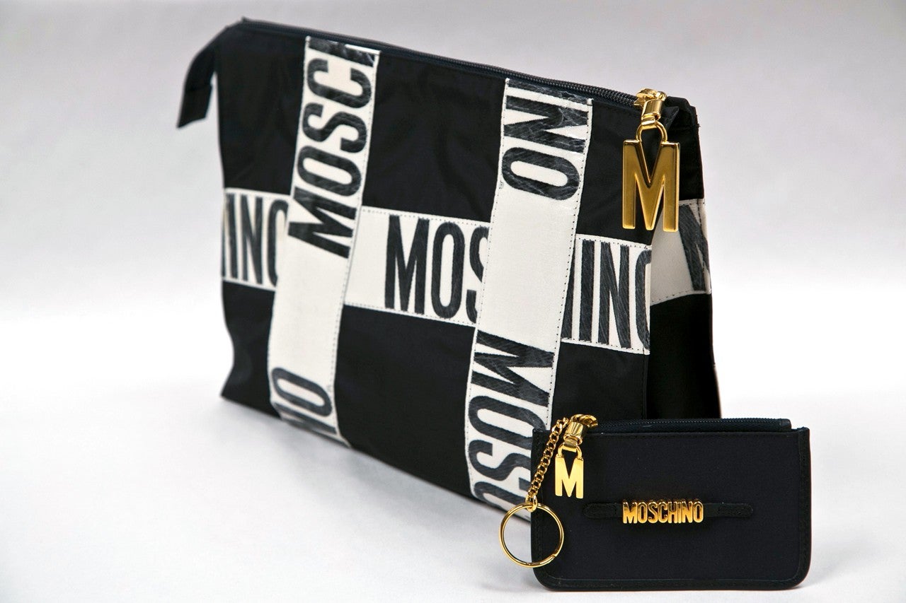 presented by funkyfinders a never used moschino redwall 'print' clutch. it debuts in new old stock condition with a bonus coin/key purse and original paperwork. an unusual collector piece.