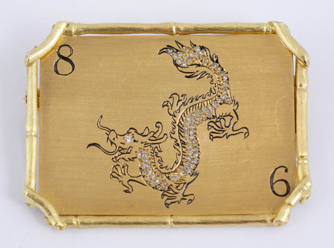 Modern 18kt gold, enamel and diamond Chinese dragon brooch measuring 45mm x 34mm.