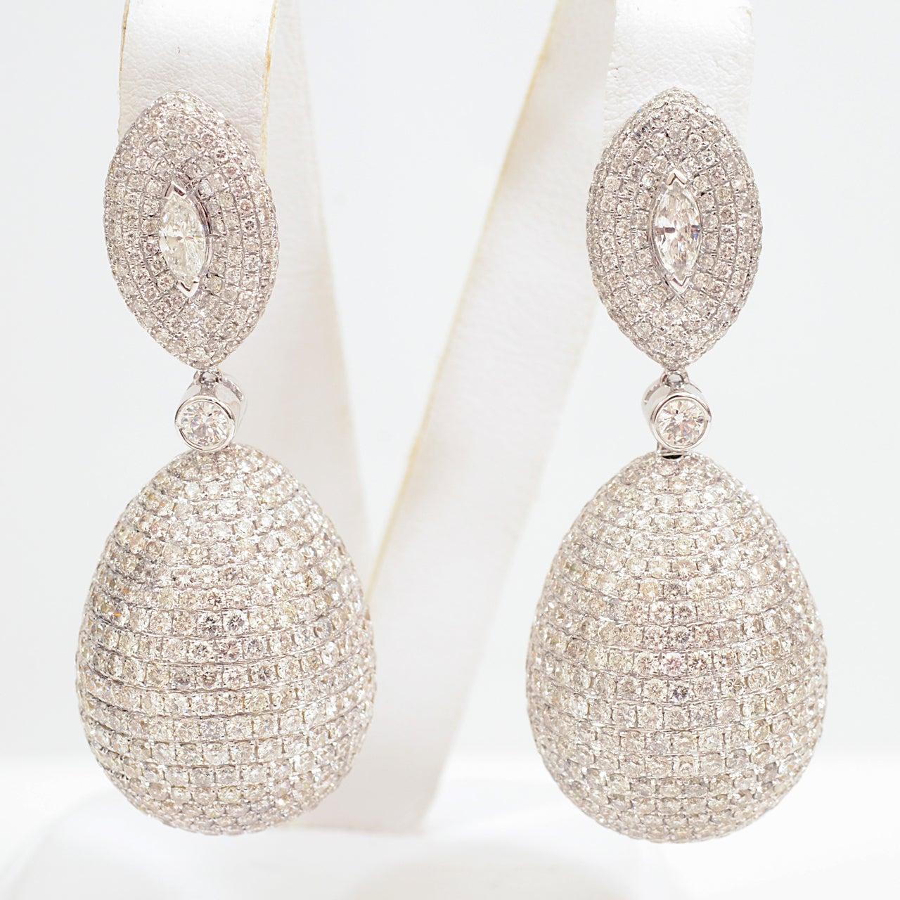 Diamond Oval Earrings. 18k White Gold; consist of 1436 Rounds and 2 Marquise of diamonds weighing approximately 25.46 carats.
 
The diamonds are F-G color.