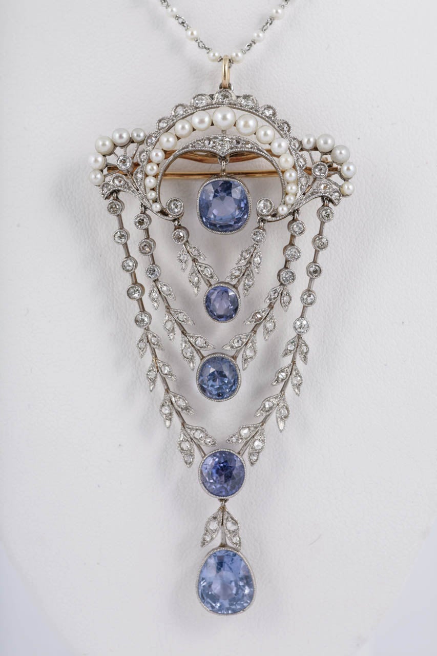 Edwardian Pendant set with Natural Ceylon Sapphires,Natural Pearls, and small Diamonds. It has a separate Platinum and Pearl chain which can be bought separately and is 17 inches long