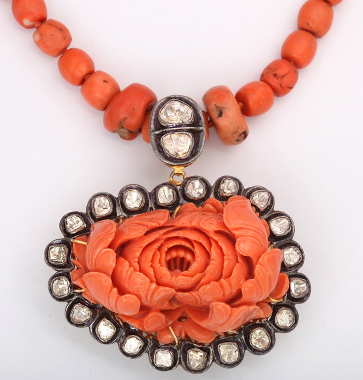 Truly, one of a kind!

Intricately hand-carved coral flower pendant, encrusted with 3.19 karat of uncut diamonds on a strand of natural coral beads.  The back of pendant is detailed with beautifully designed 14kt chiseled yellow-gold.

Pendant: