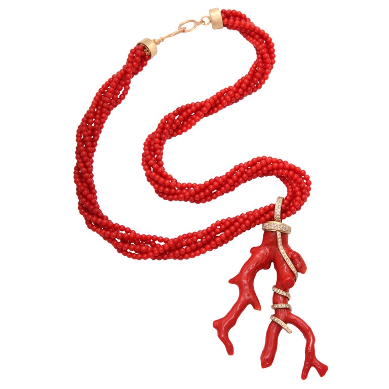 A truly one-of-a king pendant of magnificent natural coral with diamonds and 18kt brushed gold intricately snaking through the branches, hanging on six strands of beautiful coral beads with a brushed 18kt yellow-gold lock.

Has to be seen to be
