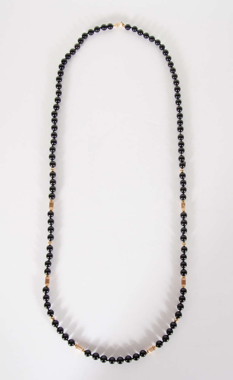 This bead necklace features 6 millimeter black onyx beads with accents of 14k gold beads throughout.