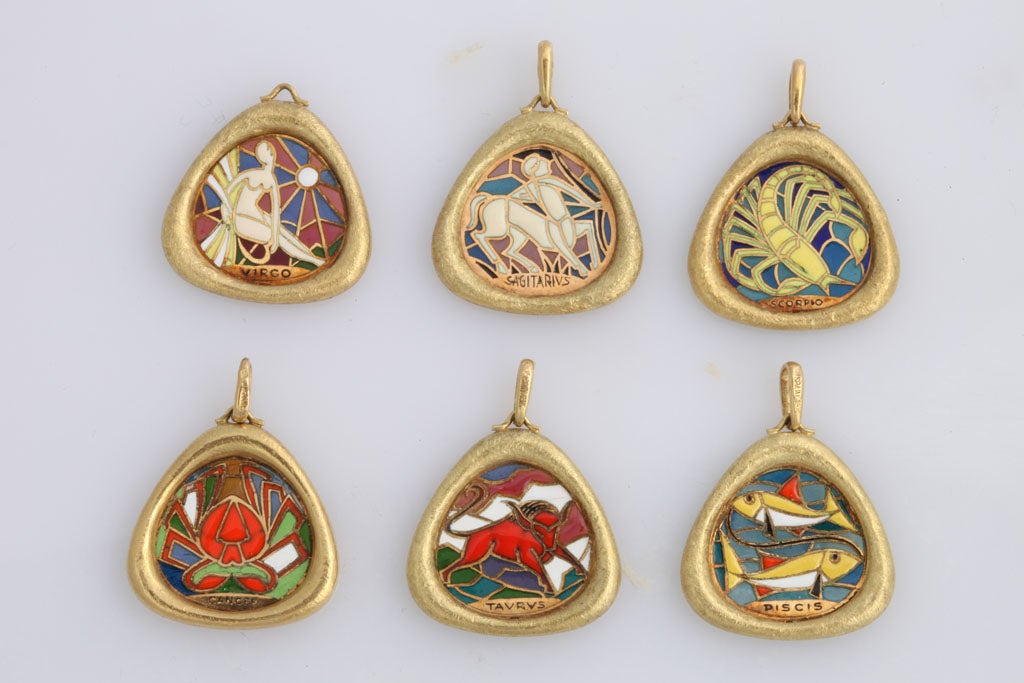 Very unusual charms representing the Zodiac signs of Sagittarius, Pisces, Virgo, Scorpio, Taurus, and Cancer. The stylized motif is executed in transparent enamel, and the gold frames are textured. These charms can either be worn on a bracelet, on a