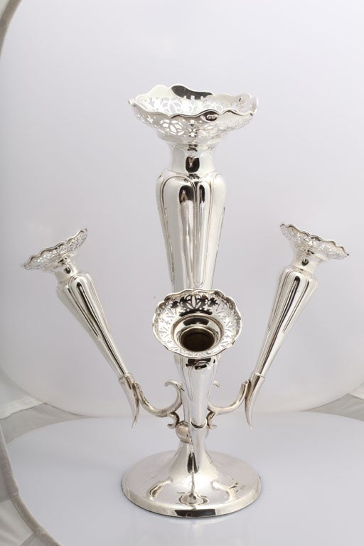 From Chester, England, this beautiful epergne centerpiece has a weighted silver base and 4 removable tulip flower holders.