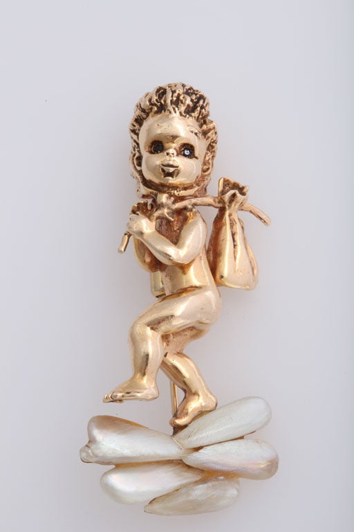 This brooch is a great example of Ruser's children of the week line. This brooch features  freshwater pearls and blue sapphire eyes. 'Thursday's Child' pin  is stamped with the signature of renowned American pin designer Ruser, and 