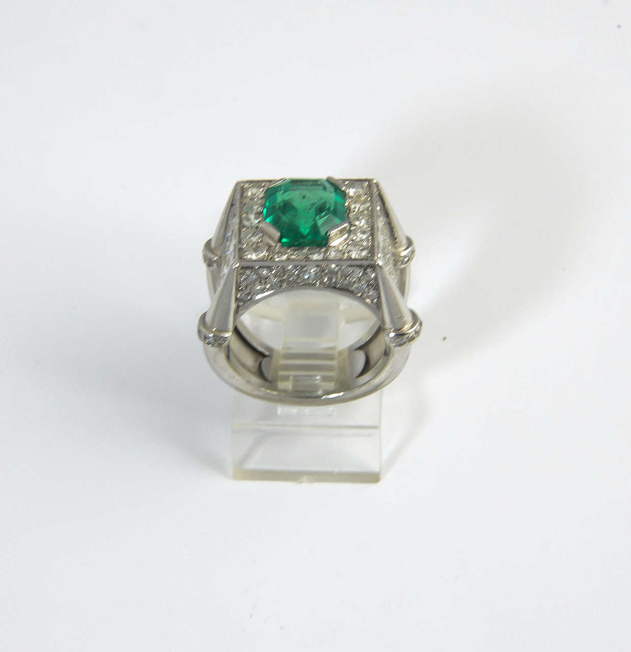 Fine 3 carat emerald set in a highly stylized 18k white gold mounting with diamonds on every side.

US size 6.5