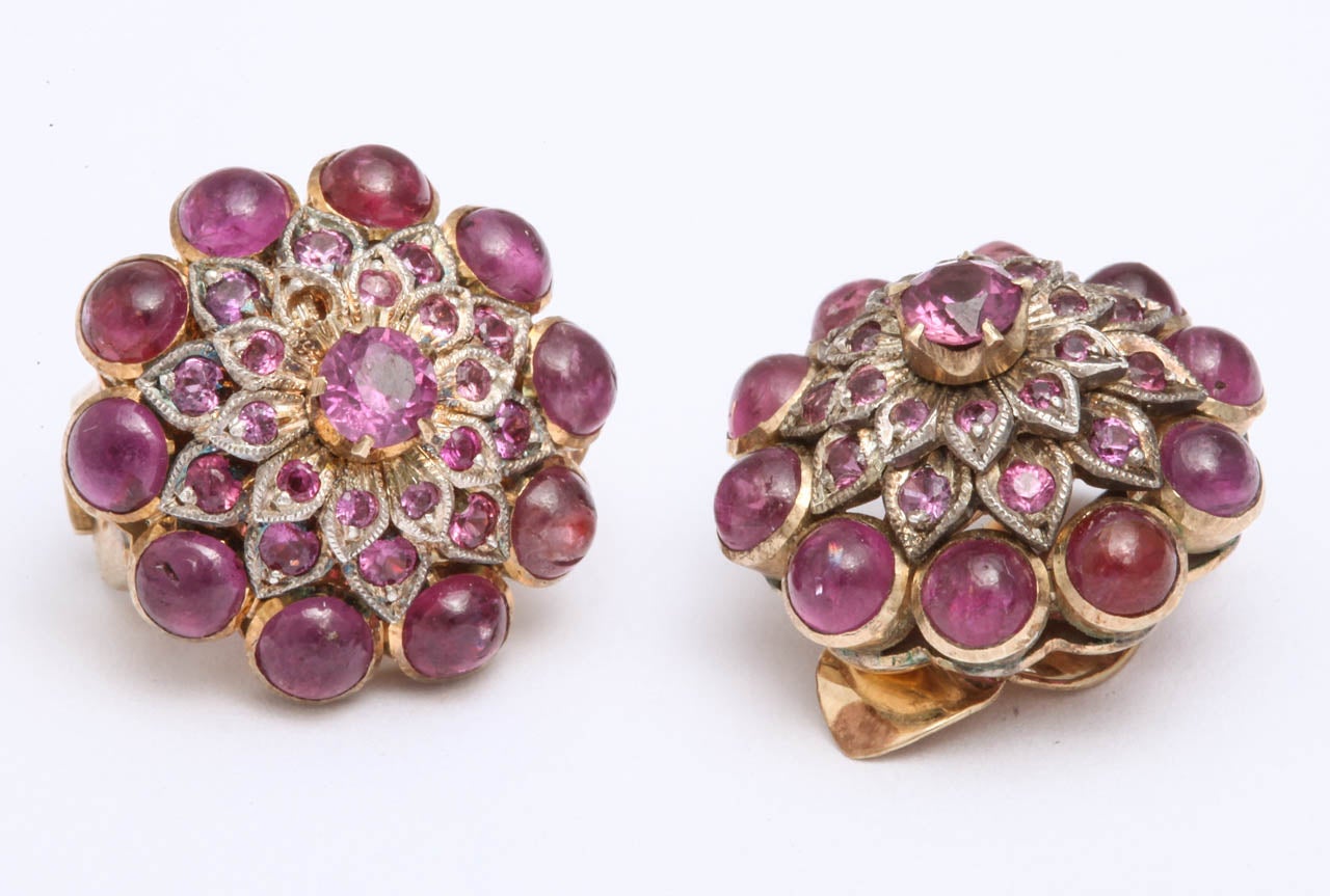18kt yellow gold clip on earrings consisting of various cabochon rubies and faceted cut rubies with fancy clip on backs