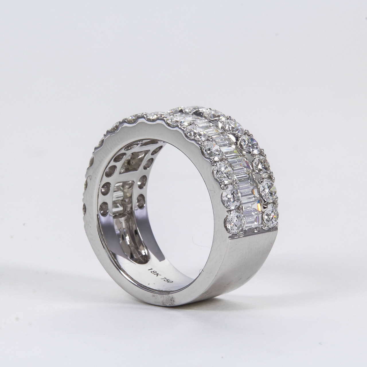 A stunning ring!

3.79 carats of extremely brilliant F/G color VS clarity round and baguette cut diamonds set in 18k white gold.

Approximately 9.5 mm wide.

Currently a size 6.5 — can be sized to any finger size. 

A perfect band for everyday or