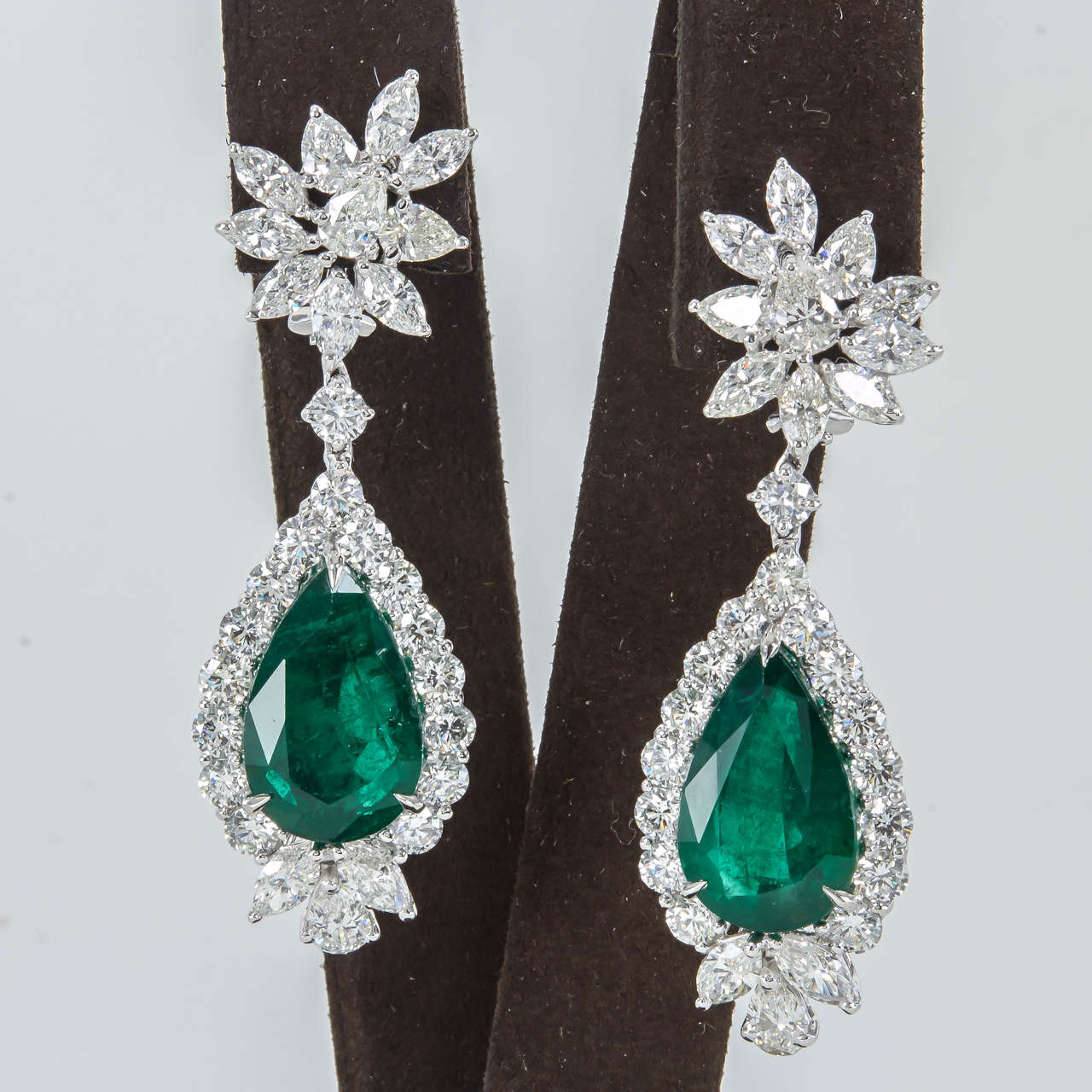 A timeless piece to add to any collection.

20.02 carats of beautiful pear shaped emeralds

11.66 carats of round, pear, and marquise cut diamonds

Handmade in platinum

The earrings are about 2.16 inches long and approximately 3/4 of an inch at its