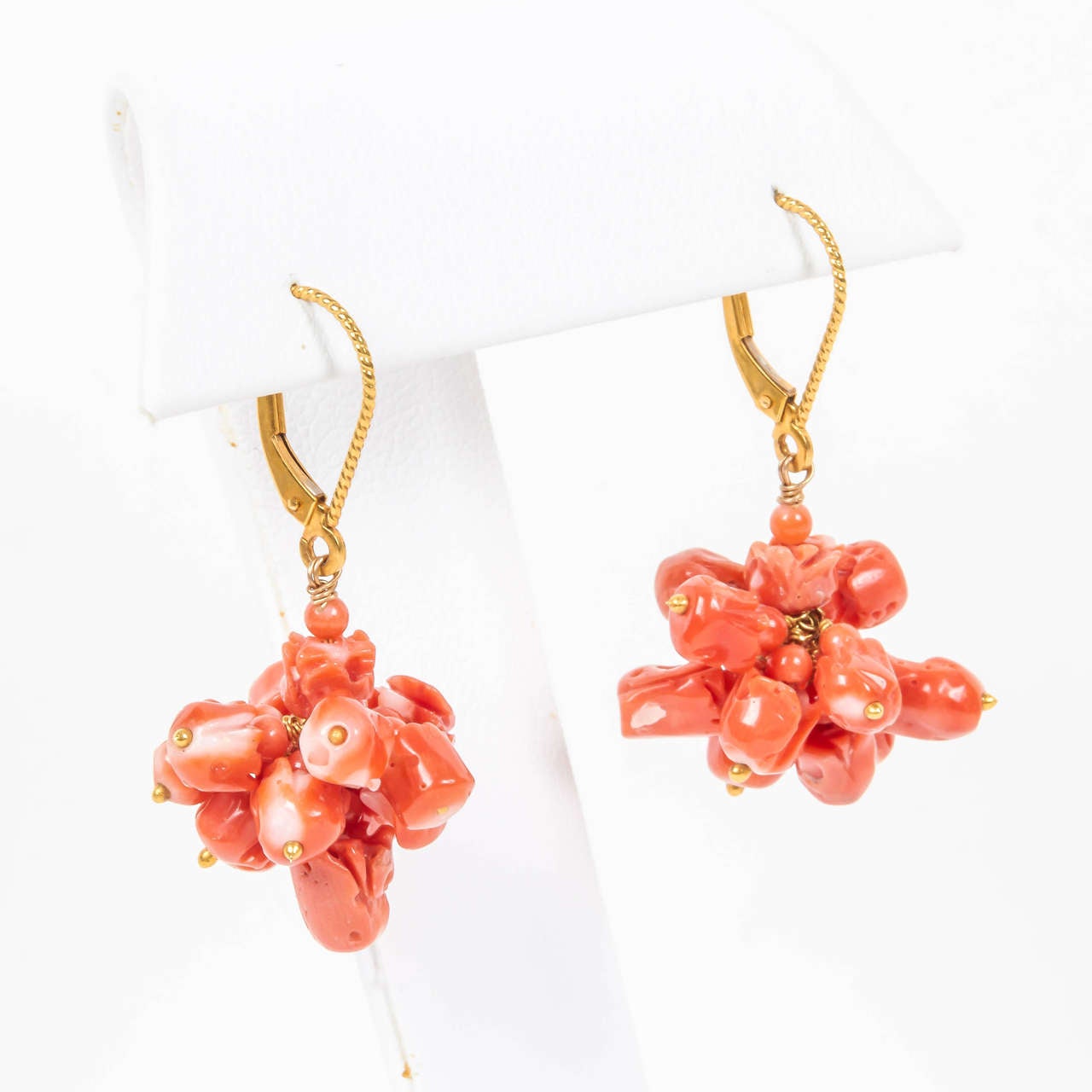 Natural coral tulips are suspended from 14kt euro wires for extra security. The charming cluster of coral tulips dangles gracefully from your ear. The matching necklace is J150319696124